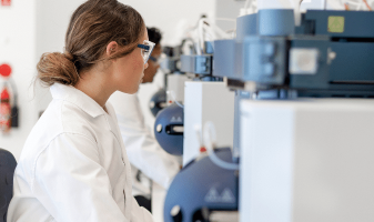 Gender diversity in life sciences and pharmaceuticals blog header image woman in lab coat working on machine stem