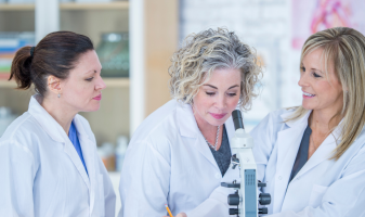 IP Blog images (in text) (2) three women in labcoats working analysing through microscope life sciences